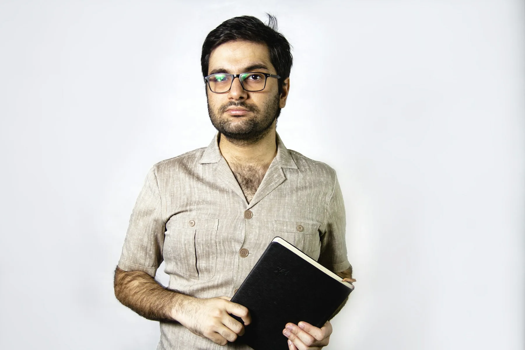 Lecturer holding a book in a studio portrait