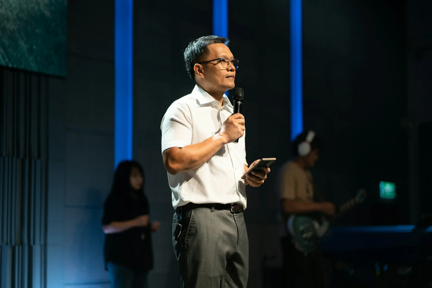 Lecturer speaking to an audience with a microphone